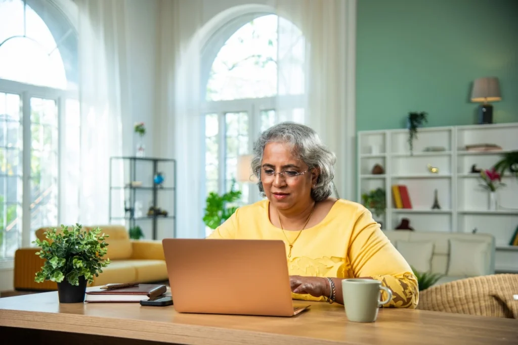 Happy woman using laptop to make an NDIS referral